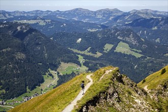 Hiker on the Fellhorngrat ridge trail between Fellhorn summit and Soellerkopf