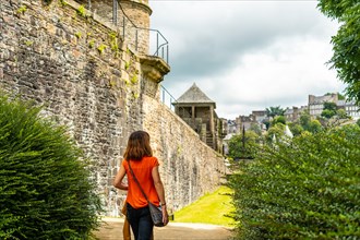 A young tourist visiting the castle of Fougeres. Brittany region