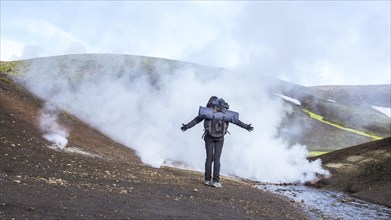 Woman in pools of boiling water on the 54 km trek from Landmannalaugar