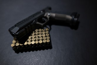 Modern Elegant Handgun and Bullet on Grey Background in Switzerland