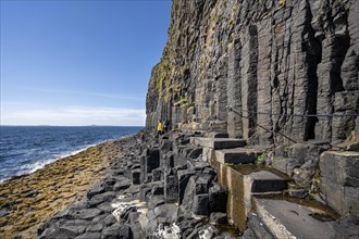 Footpath with steps and safety rope along the basalt columns to Fingal's Cave on the uninhabited rocky island of Staffa