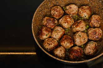 Scandinavian meatballs with green pea and cranberry jam in a frying pan