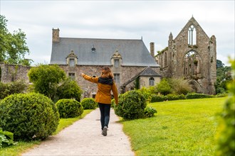 A young tourist visiting Abbaye de Beauport in the village of Paimpol