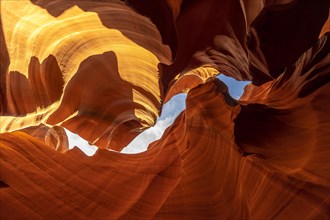 Mix of orange and red textures and curve in Lower Antelope and the blue sky above in Arizona. United States