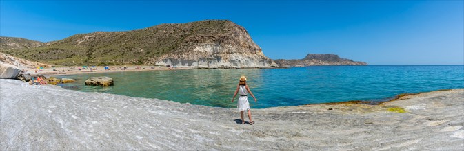 Panoramic of a young woman on Enmedio beach in Cabo de Gata on a beautiful summer day