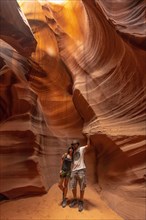 A couple admiring the beauty of the Upper Antelope Canyon in the town of Page