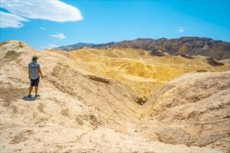 Panoramic of a young man enjoying the view of the Zabriskie Point viewpoint
