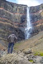A young man looking at one of the wonders of Iceland