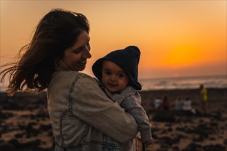 A young mother with her son at the Toston Lighthouse Sunset