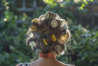 Woman's head from behind with curlers
