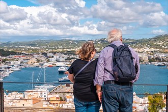 An elderly couple looking at the city from the cathedral of Santa Maria de Ibiza