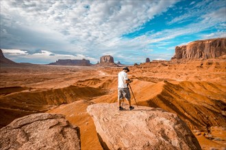 A European photographer at John Ford's Point in Monument Valley preparing a panor. Utah