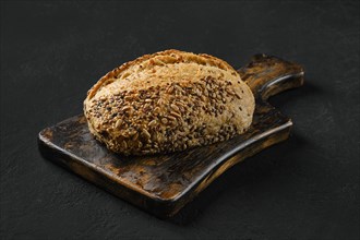 Whole loaf of artisan bread with sunflower and sesame seeds