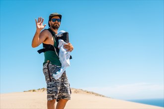 A young man enjoying the summer with his son on the sand dune at Monsul beach in Cabo de Gata Natural Park