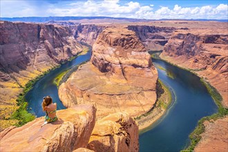Young tourist girl with green dress in Horseshoe Bend
