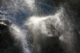 Water splashing against rocks and mist in the air at a waterfall in the state of Minas Gerais