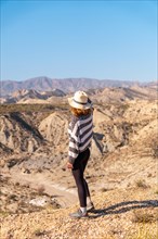 A young hiker in the desert canyon of Tabernas