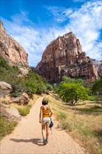 A young woman starting the trekking climb of the Angels Landing Trail in Zion National Park