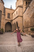 Blonde girl walking in a medieval castle