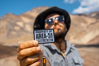 A young man with a patch for Area 51 clothing on Artist's Drive in Death Valley