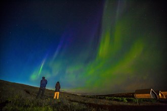 A couple in Northern lights in the sky on the Reykjanes peninsula in southern Iceland