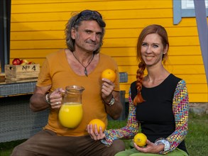 Man and woman presenting freshly prepared juices