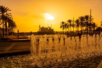 Orange sunset at the fountains of the Rambla de Almeria