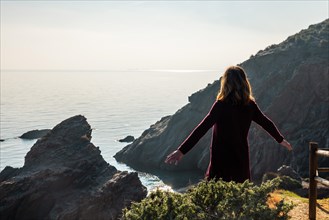 A young tourist looking at the beach in the Almanzora caves