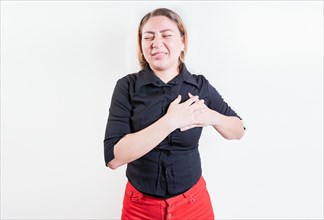 Latin woman with heart pain on isolated background. Young woman with tachycardia. Concept of people with heart problems