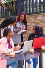 Young and alternative businesswomen of black ethnicity. In a team-building meeting