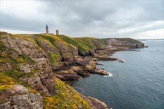 The beautiful coastline next to the Phare Du Cap Frehel is a maritime lighthouse in Cotes-dÂ´Armor France . At the tip of Cap Frehel