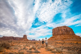 A couple in the Monument Valley National Park in Three Sisters. Utah