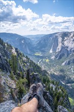 Sitting winged from Taft point looking at Yosemite National Park and El Capitan. United States