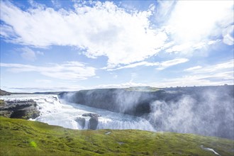 The Gullfoss waterfall in the golden circle of the south of Iceland with lots of water one summer morning