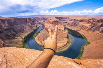 The peace symbol on Horseshoe Bend and the Colorado River in the background