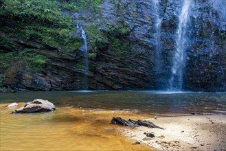 Waterfalls trickling down rocks into a small lake in Minas Gerais