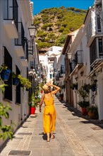 A tourist in Mijas visiting the white houses and the slopes in Malaga. Andalusia