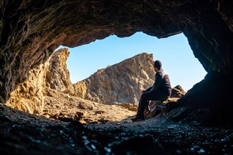 A young tourist sitting in the Almanzora caves