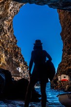 A young woman inside the cave of the town of Poris de Candelaria on the north-west coast of the island of La Palma
