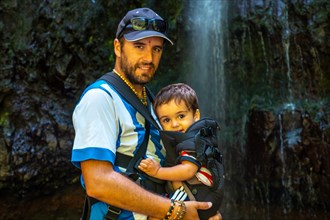 A father with his son on the waterfall trek at Levada do Caldeirao Verde