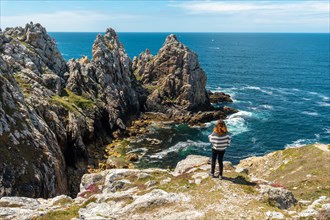A young woman on vacation at Pen Hir Point on the Crozon Peninsula in French Brittany