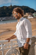 Summer lifestyle with a young dark-haired Caucasian man with long beard
