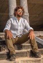 Summer lifestyle with a young dark-haired Caucasian man with long beard