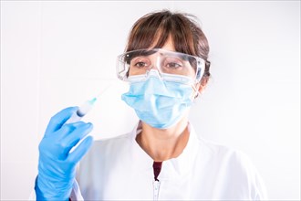 Female doctor with transparent glasses face mask with coronavirus vaccine