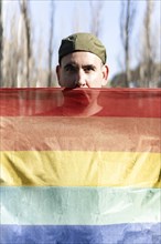 Gay man holding LGBT rainbow flag