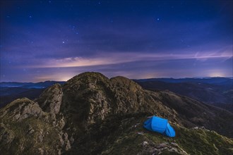 A tent under the stars on Mount Penas de Aya in Oiartzun. Basque Country