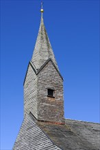 Tower of the Chapel of St. Nicholas and St. Magdalene with many wooden shingles in Linsen near Niedersonthofen