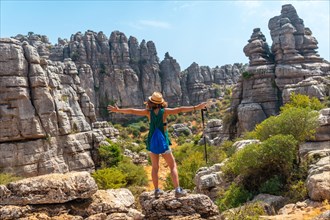 A young woman in Torcal de Antequera on the green and yellow trail enjoying freedom