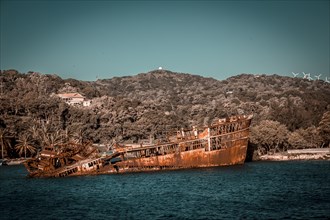 Boat with abandoned rock in the port of Roatan. Honduras