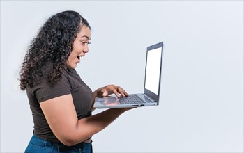 Surprised girl looking at an promotion on laptop screen isolated. Amazed latin woman using laptop isolated. Latin people looking offer promo on laptop isolated